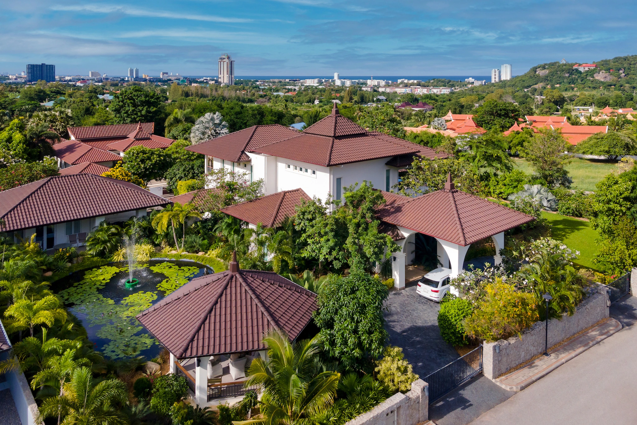 Villa 18 at BelVida, surrounded by tropical gardens with the Hua Hin coastline beyond